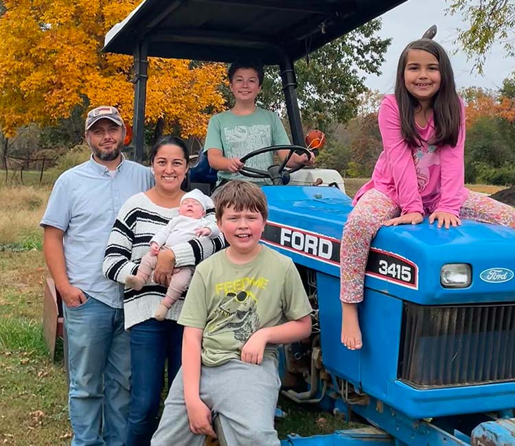 The Johnson family around a tractor